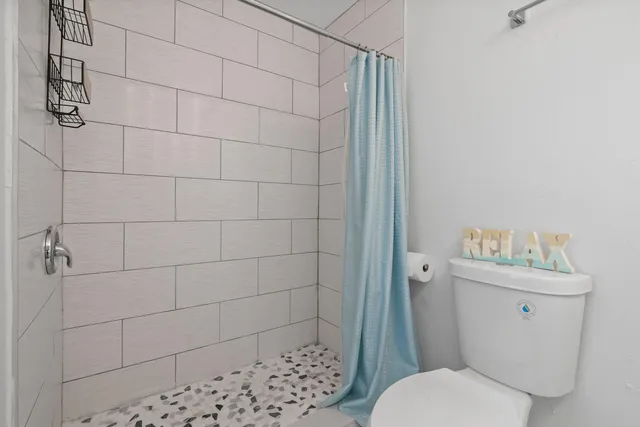 a white toilet sitting next to a bathroom sink