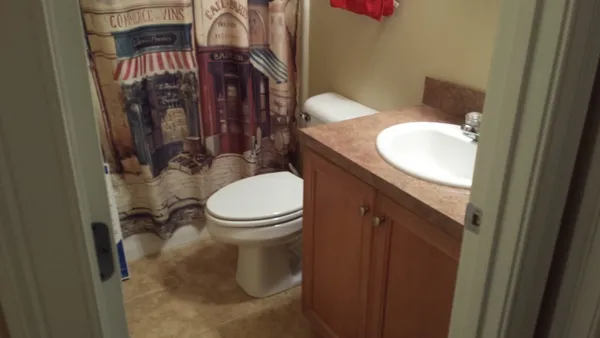a white toilet sitting next to a bathroom sink