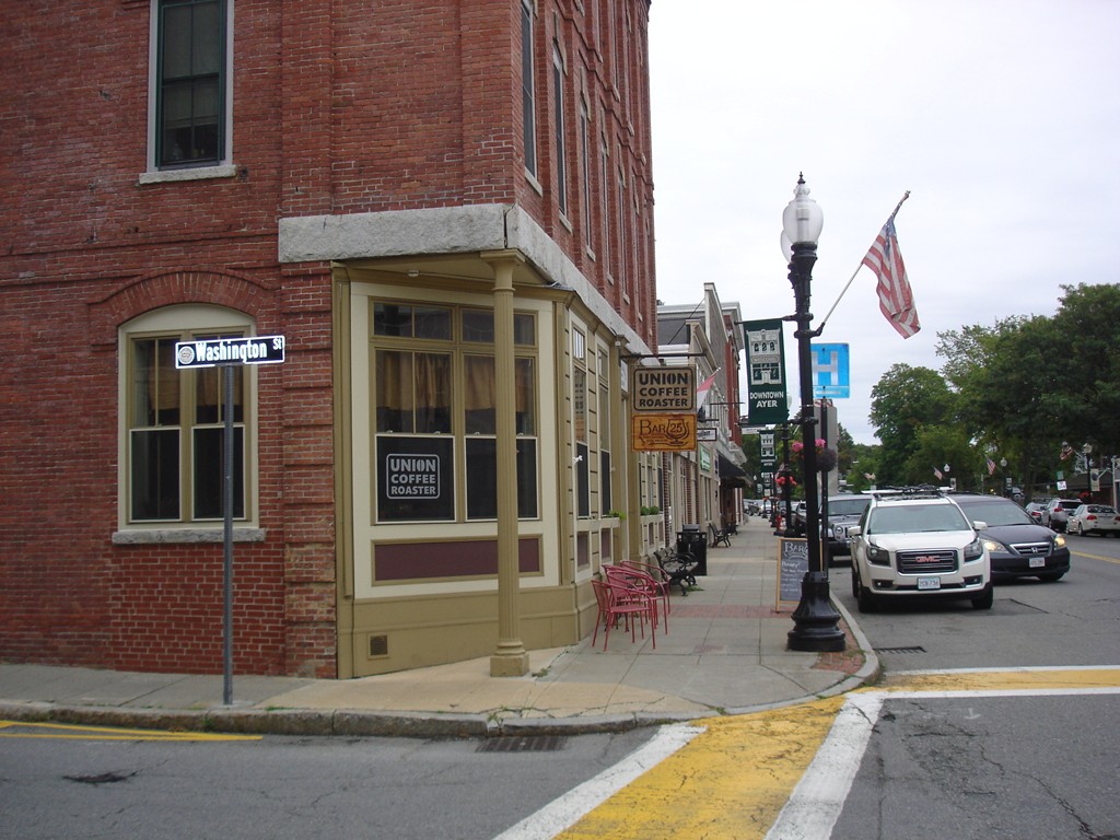 25 Main Street, Unit 3C Ayer, MA 01432 - Photo 8 of 8 a view of a building with car parked on the road