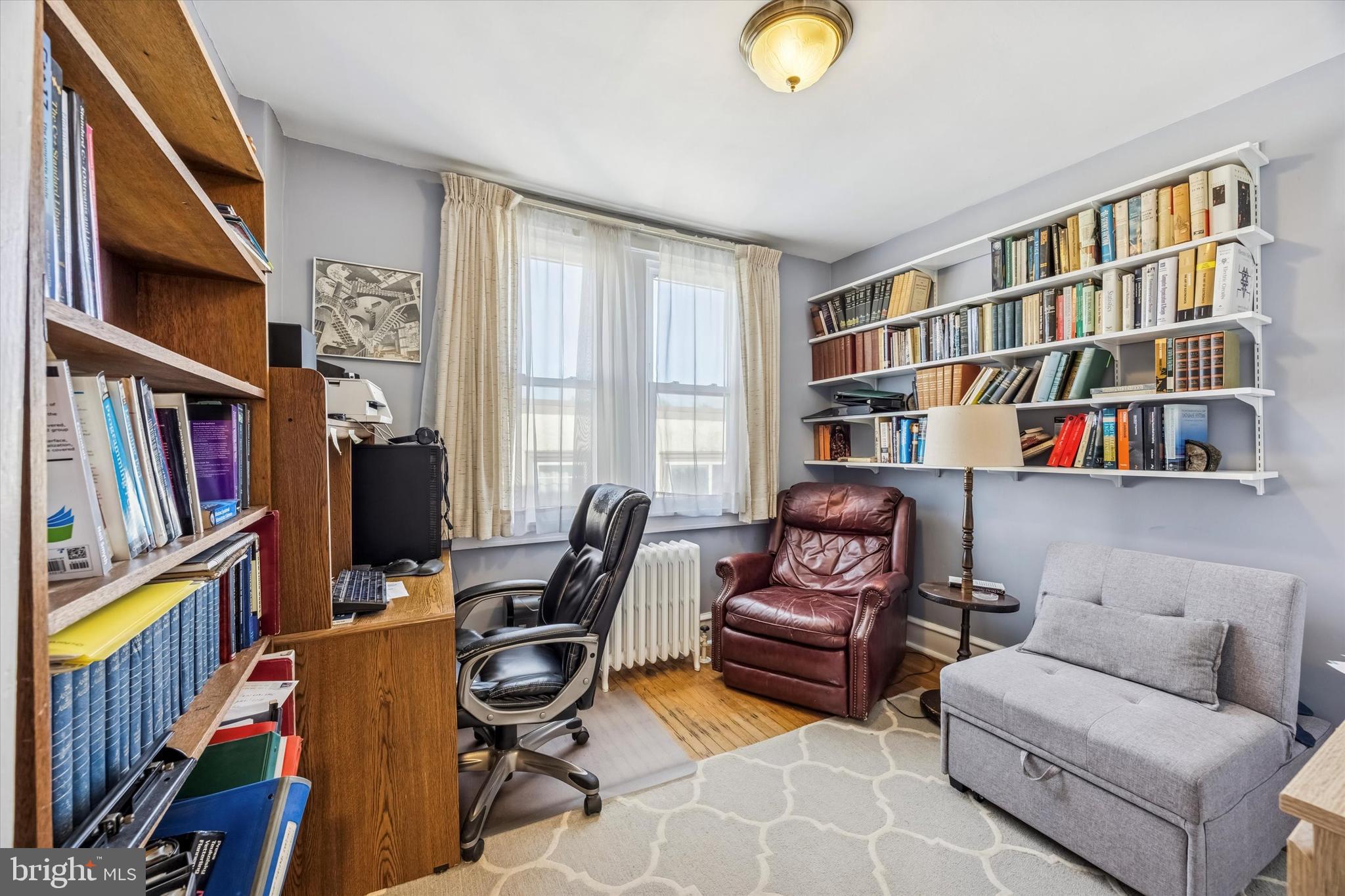 4032 Dayton Road Drexel Hill, PA 19026 - Photo 17 of 22 a living room with fireplace furniture and a book shelf