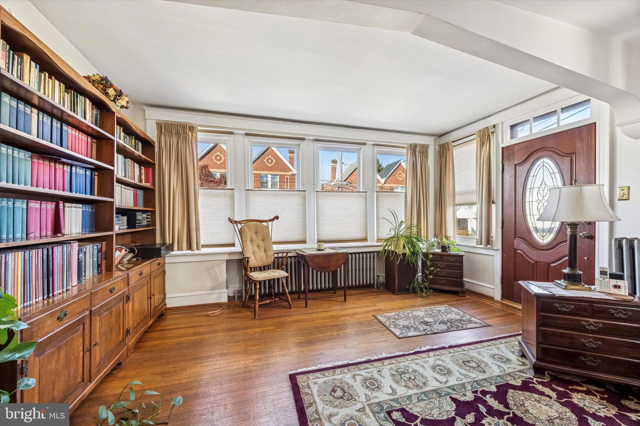 4032 Dayton Road Drexel Hill, PA 19026 - Photo 2 of 22 a living room with furniture and a book shelf