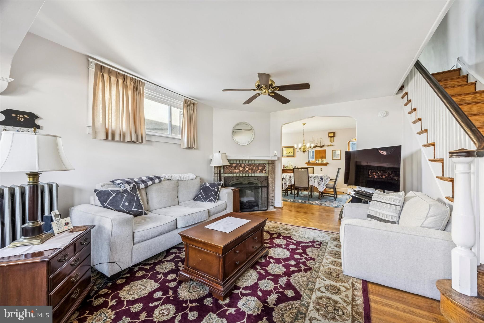 4032 Dayton Road Drexel Hill, PA 19026 - Photo 4 of 22 a living room with furniture a fireplace and a flat screen tv