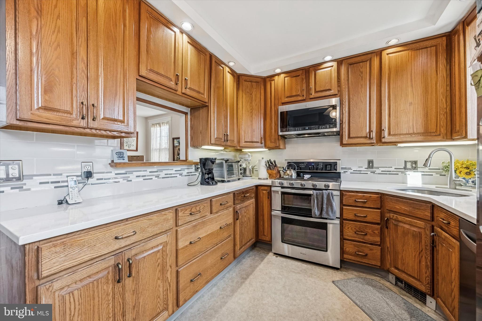 4032 Dayton Road Drexel Hill, PA 19026 - Photo 9 of 22 a kitchen with cabinets stainless steel appliances and a sink