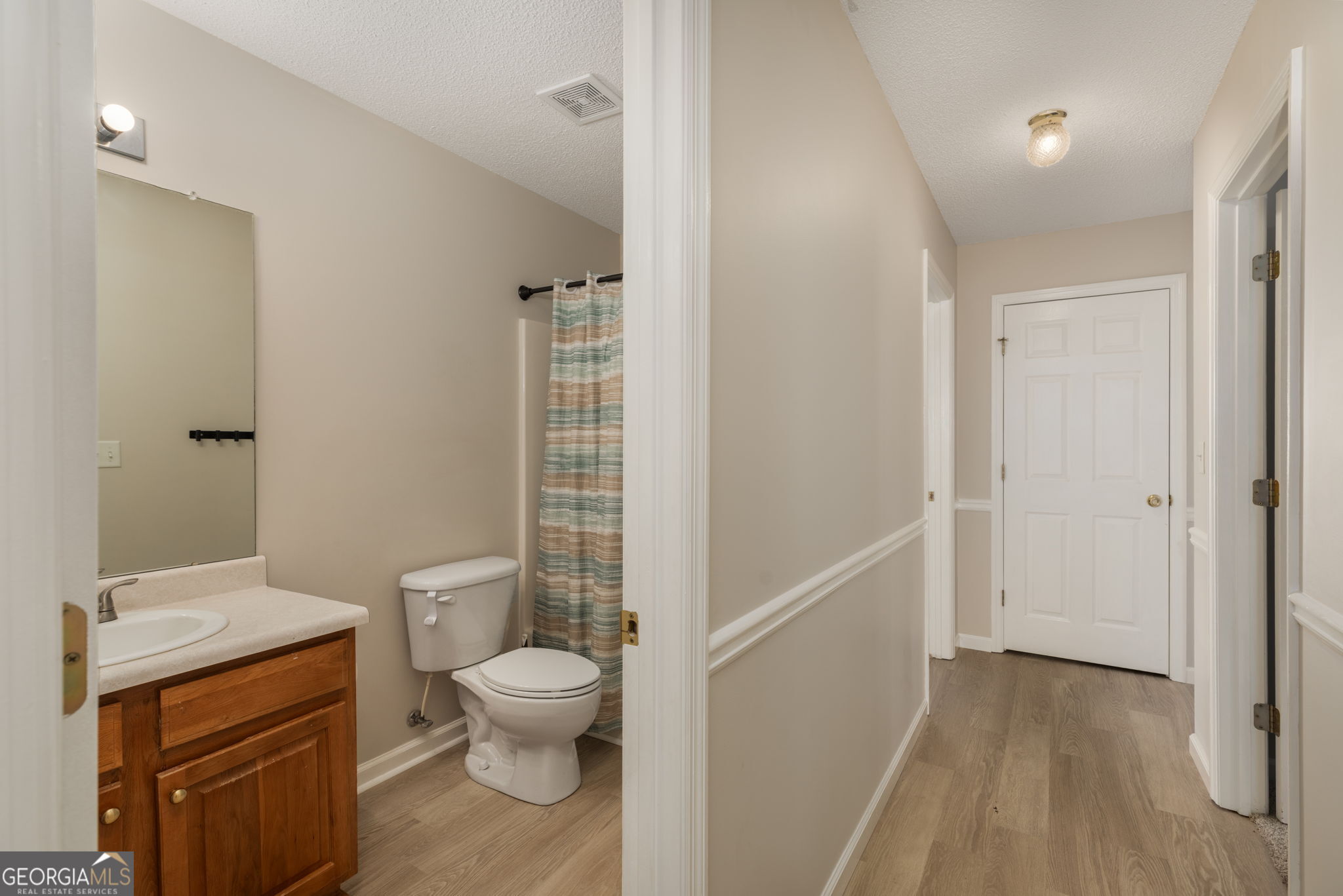 543 Pointe W Drive Dublin, GA 31021 - Photo 29 of 37 a bathroom with a granite countertop toilet a sink and a mirror