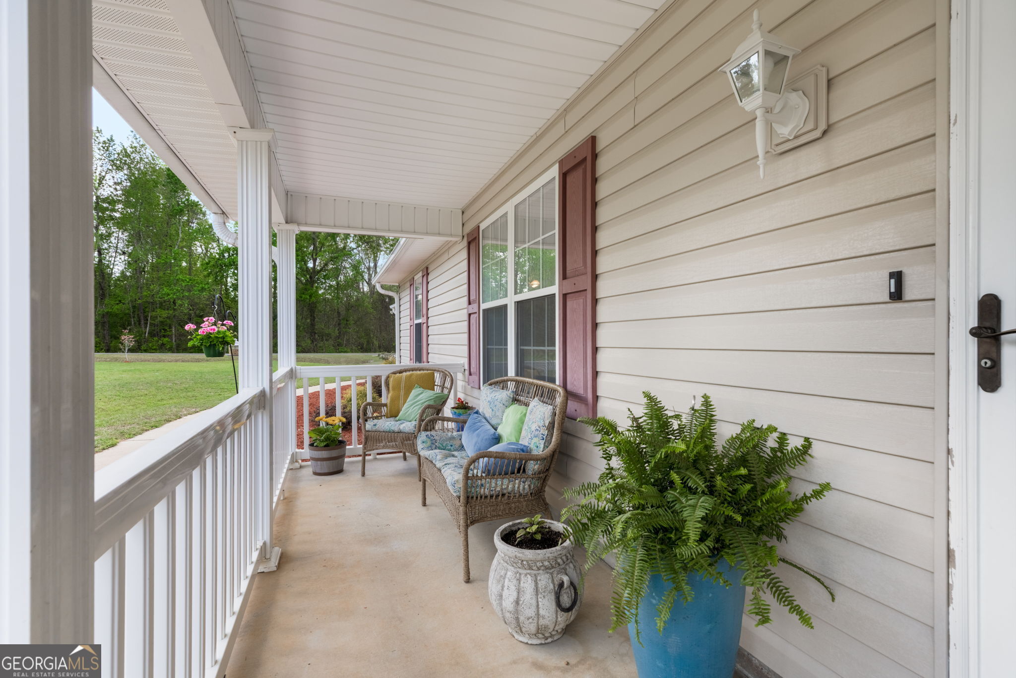543 Pointe W Drive Dublin, GA 31021 - Photo 3 of 37 a view of a porch with chairs and a potted plant