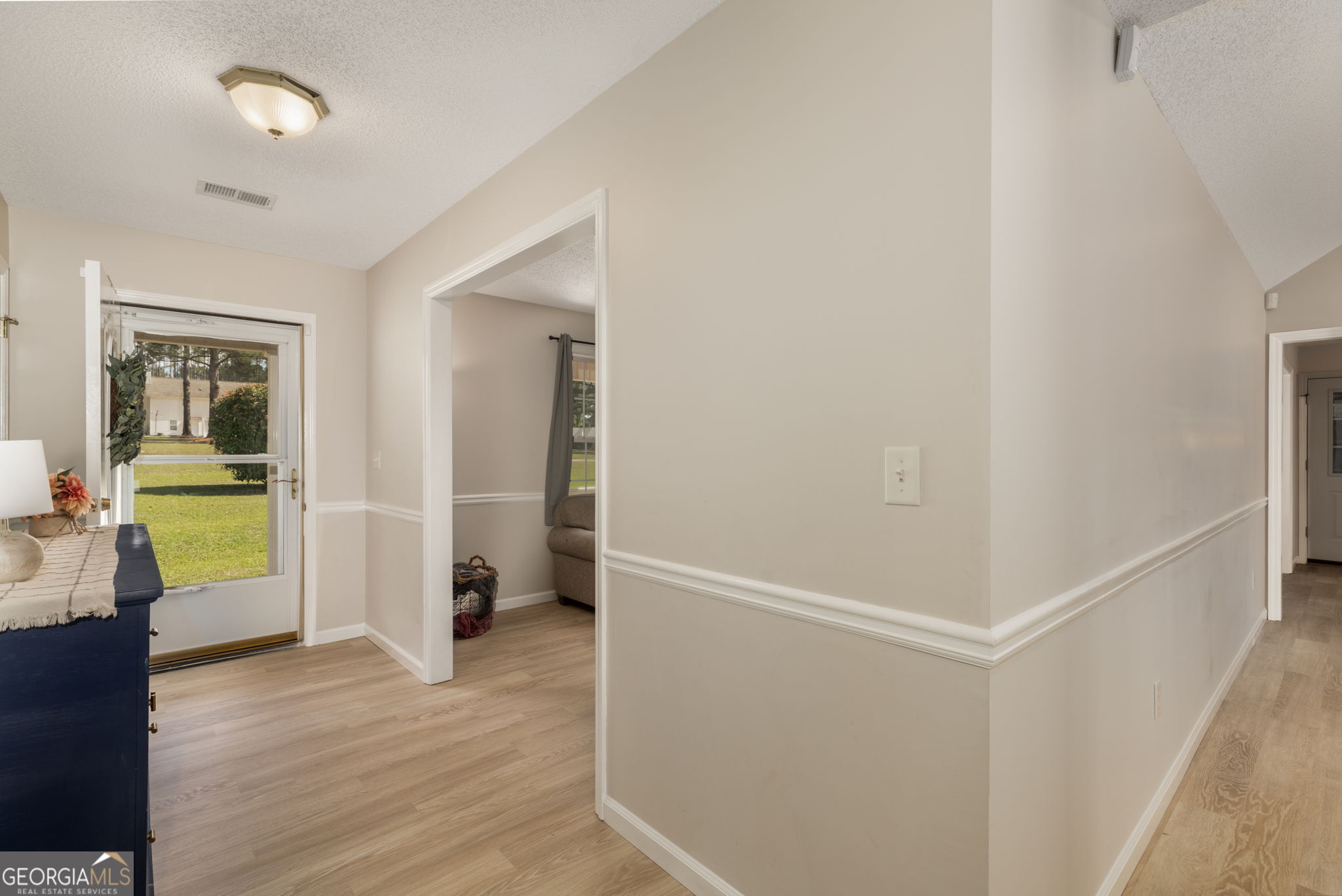 543 Pointe W Drive Dublin, GA 31021 - Photo 5 of 37 a view of an empty room with wooden floor and a window