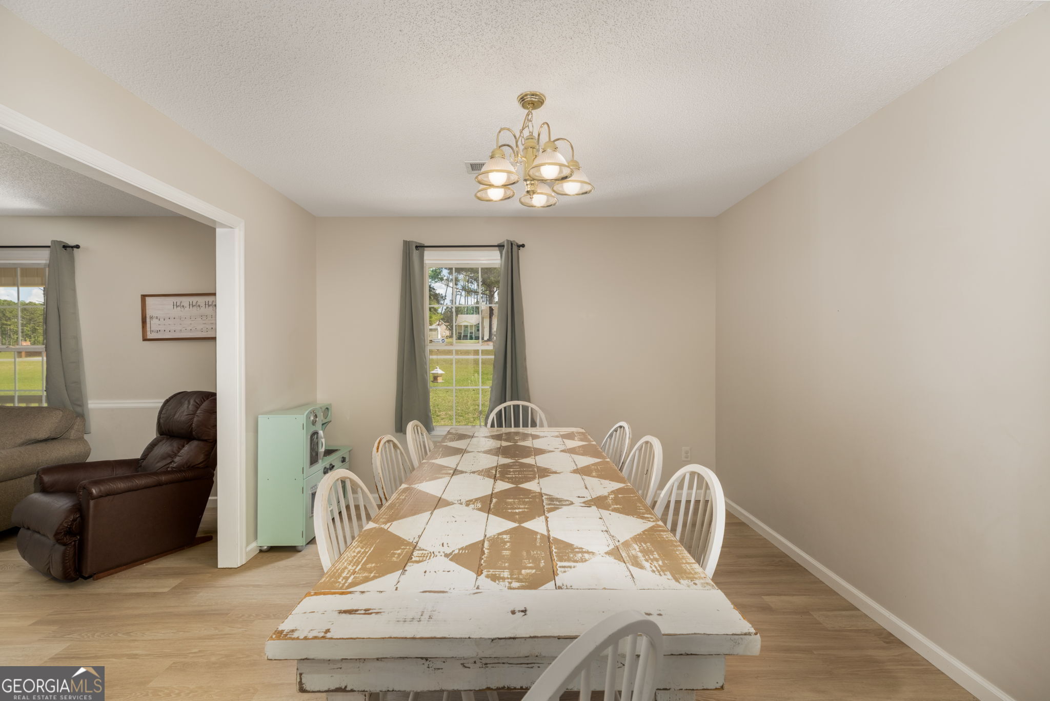 543 Pointe W Drive Dublin, GA 31021 - Photo 9 of 37 a view of a dining room with furniture and wooden floor