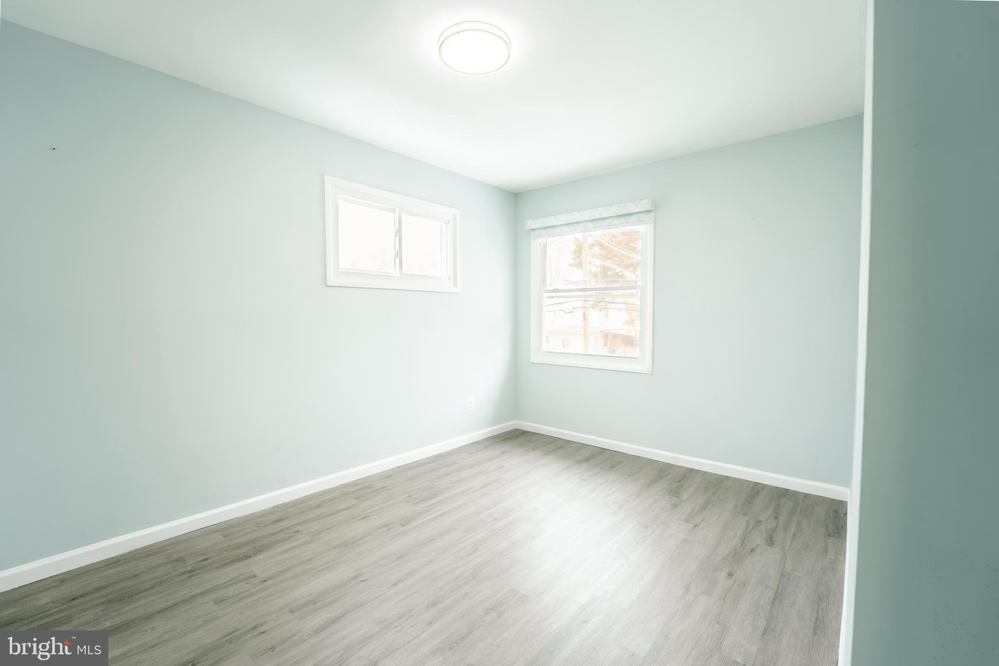 3410 Embry Street Silver Spring, MD 20902 - Photo 17 of 28 an empty room with wooden floor and windows