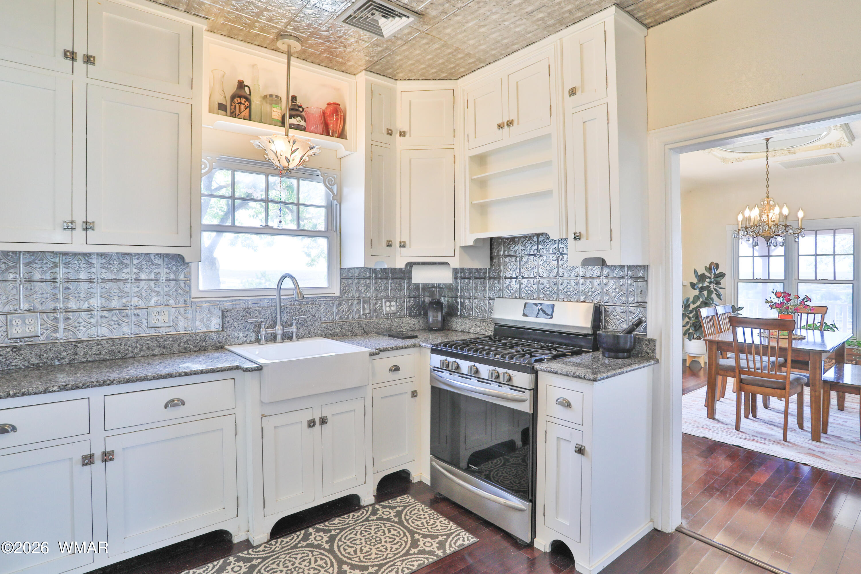102 Crestview Road Holbrook, AZ 86025 - Photo 12 of 55 a kitchen with stainless steel appliances granite countertop a stove a sink and a white cabinets