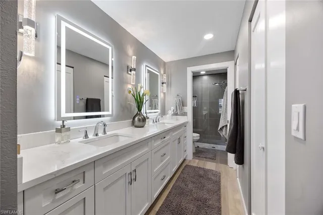 a bathroom with a double vanity sink mirror and double