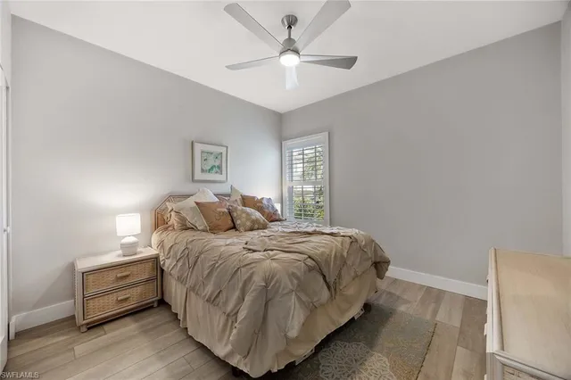 a bedroom with a bed and a ceiling fan