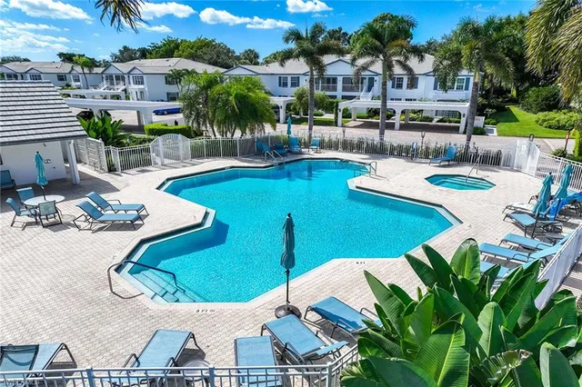 a view of a swimming pool with outdoor seating