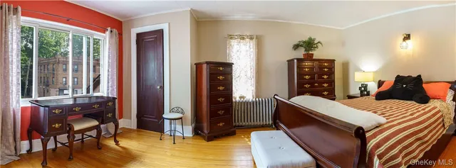 a bedroom with a bed and a window