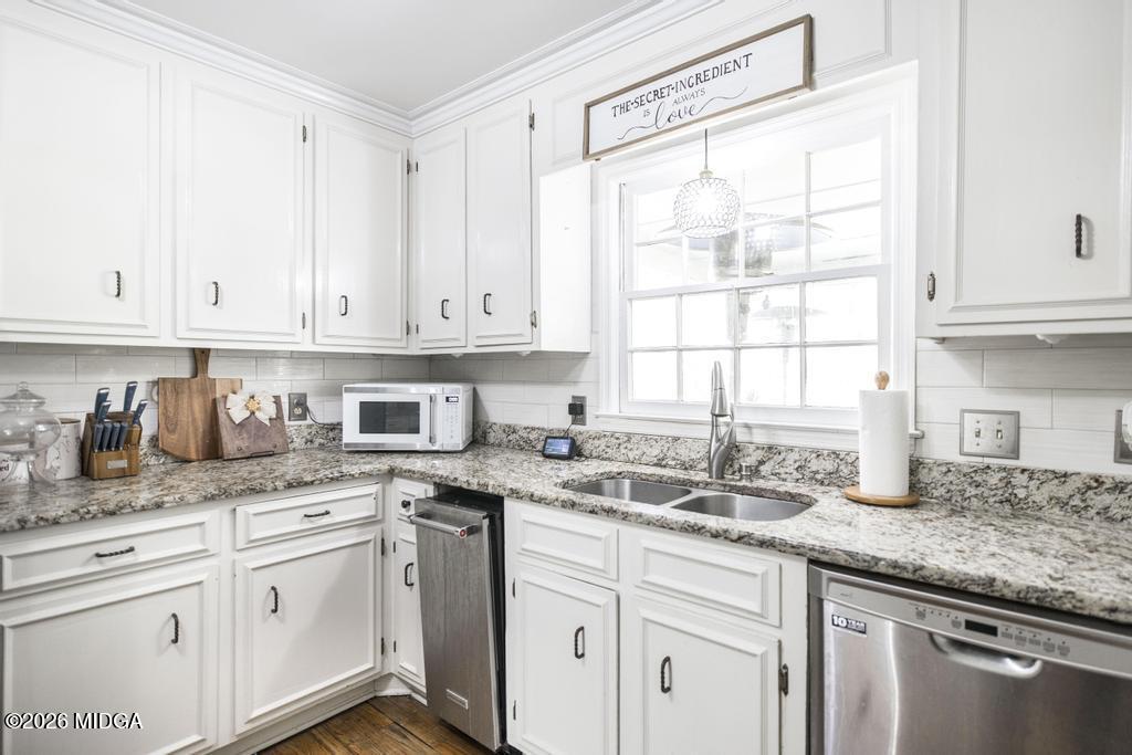 4759 Oxford Road Macon, GA 31210 - Photo 12 of 42 a kitchen with granite countertop white cabinets and white appliances