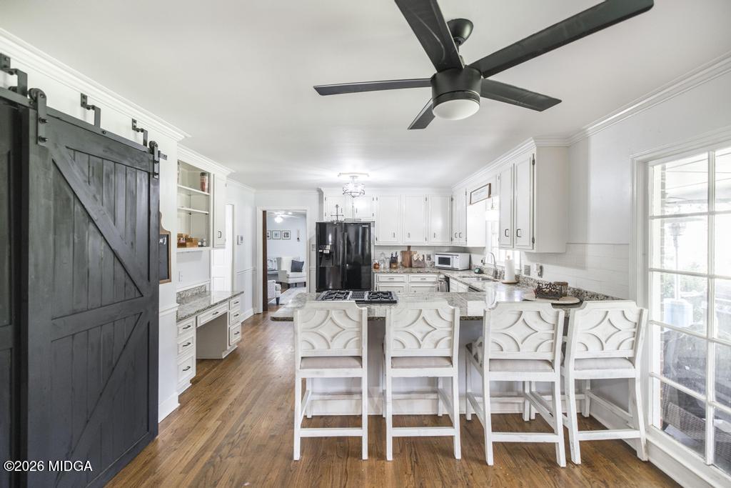 4759 Oxford Road Macon, GA 31210 - Photo 14 of 42 a view of a dining room with furniture and a ceiling fan