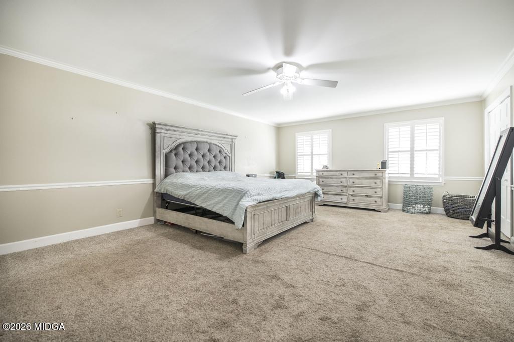 4759 Oxford Road Macon, GA 31210 - Photo 22 of 42 a spacious bedroom with a bed a couch and a ceiling fan