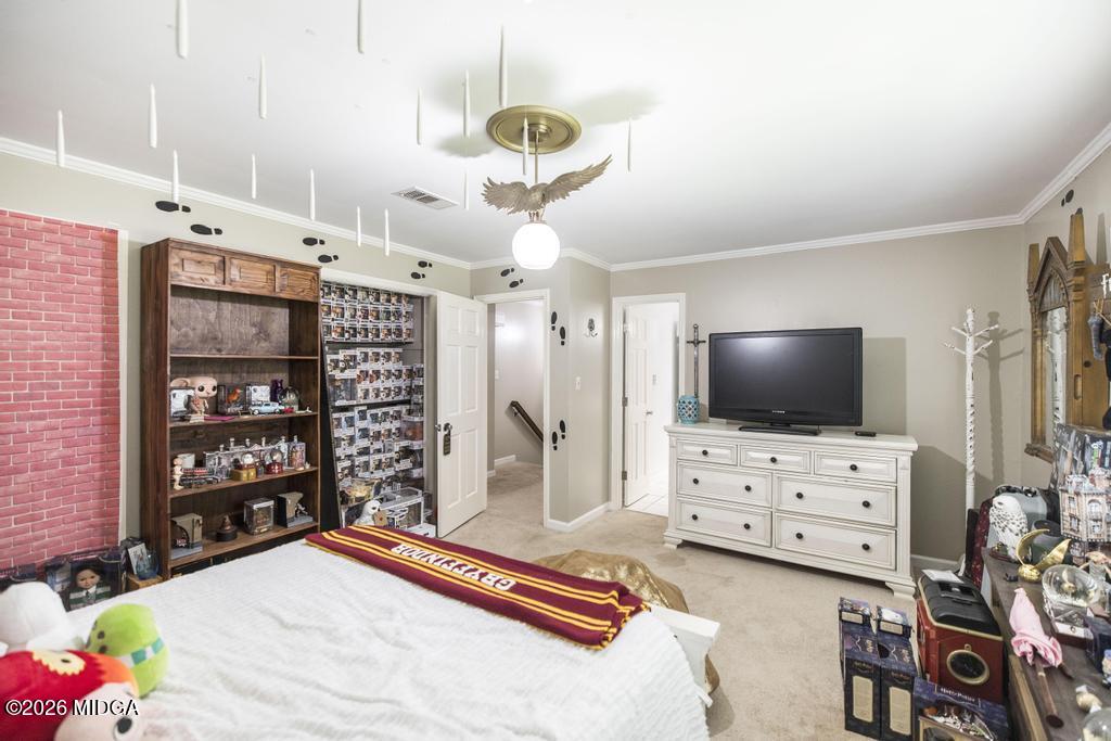 4759 Oxford Road Macon, GA 31210 - Photo 29 of 42 a bedroom with furniture and a flat screen tv