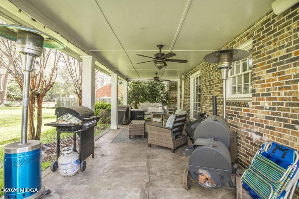 4759 Oxford Road Macon, GA 31210 - Photo 39 of 42 a view of a patio with couches table and chairs and potted plants