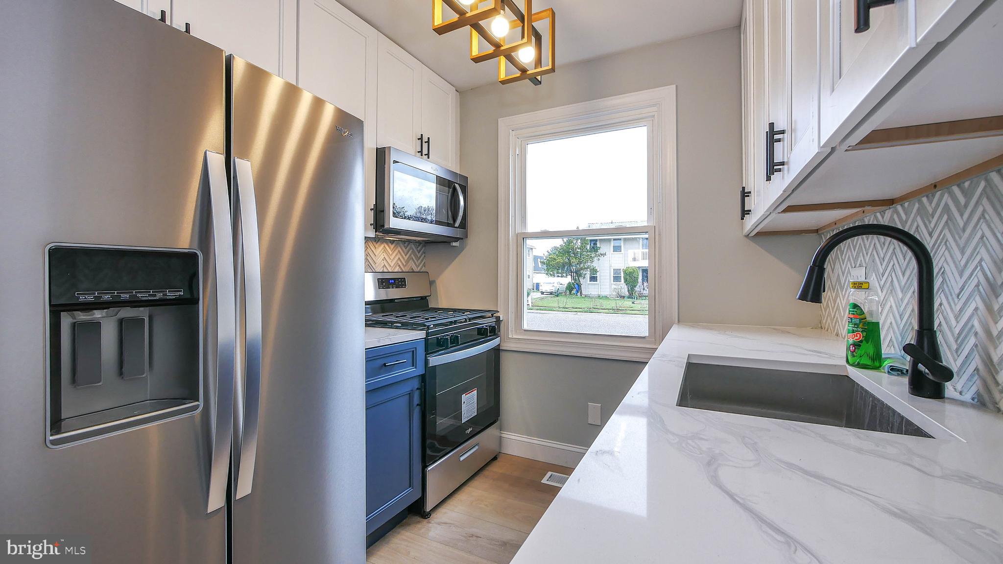 4623 Schooner Road, Unit A Brigantine, NJ 08203 - Photo 14 of 30 a kitchen with stainless steel appliances granite countertop a refrigerator and a sink