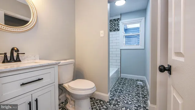 a bathroom with a sink a toilet and a shower