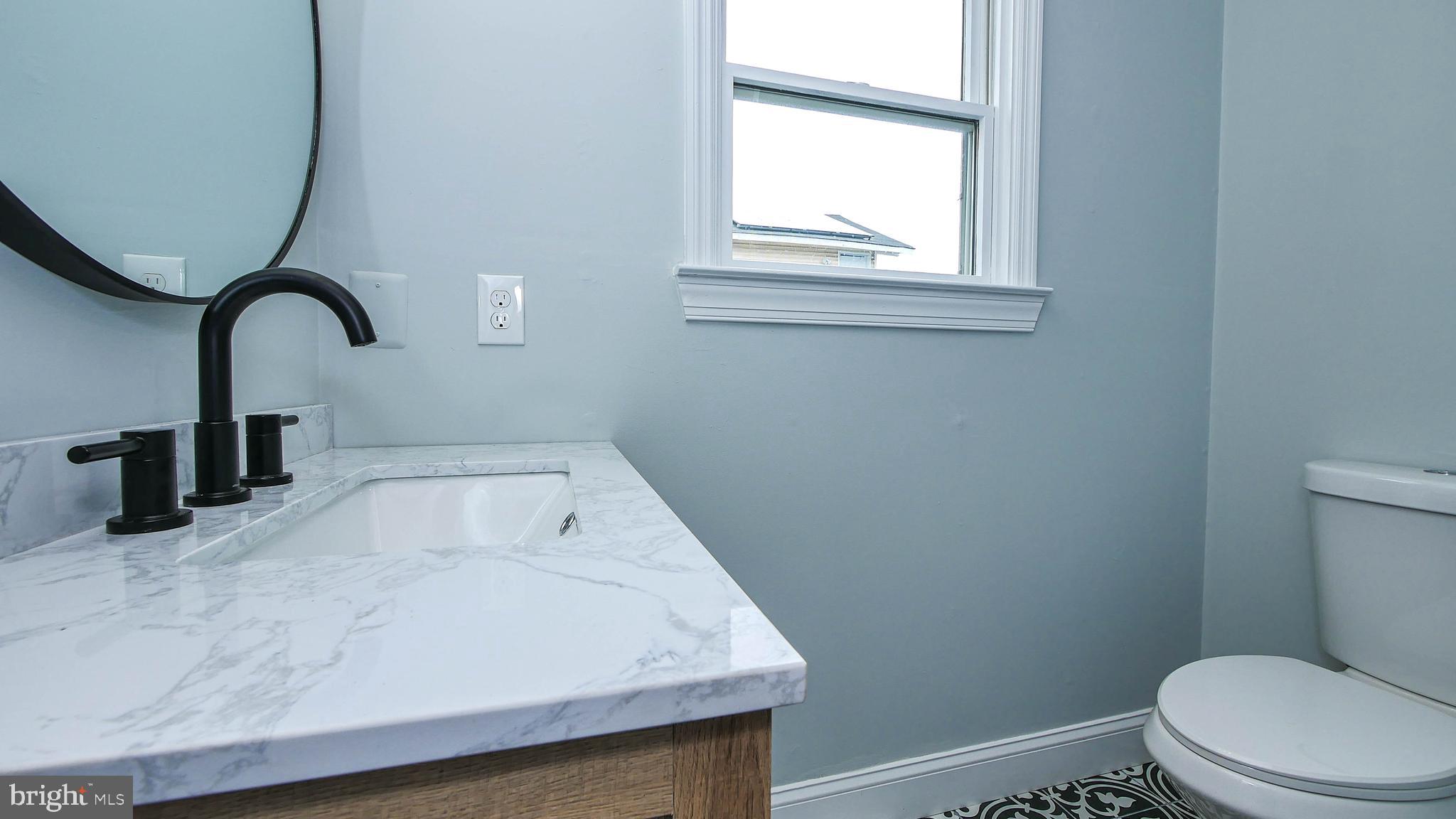 4623 Schooner Road, Unit A Brigantine, NJ 08203 - Photo 21 of 30 a close view of a sink a toilet and a window in the bathroom