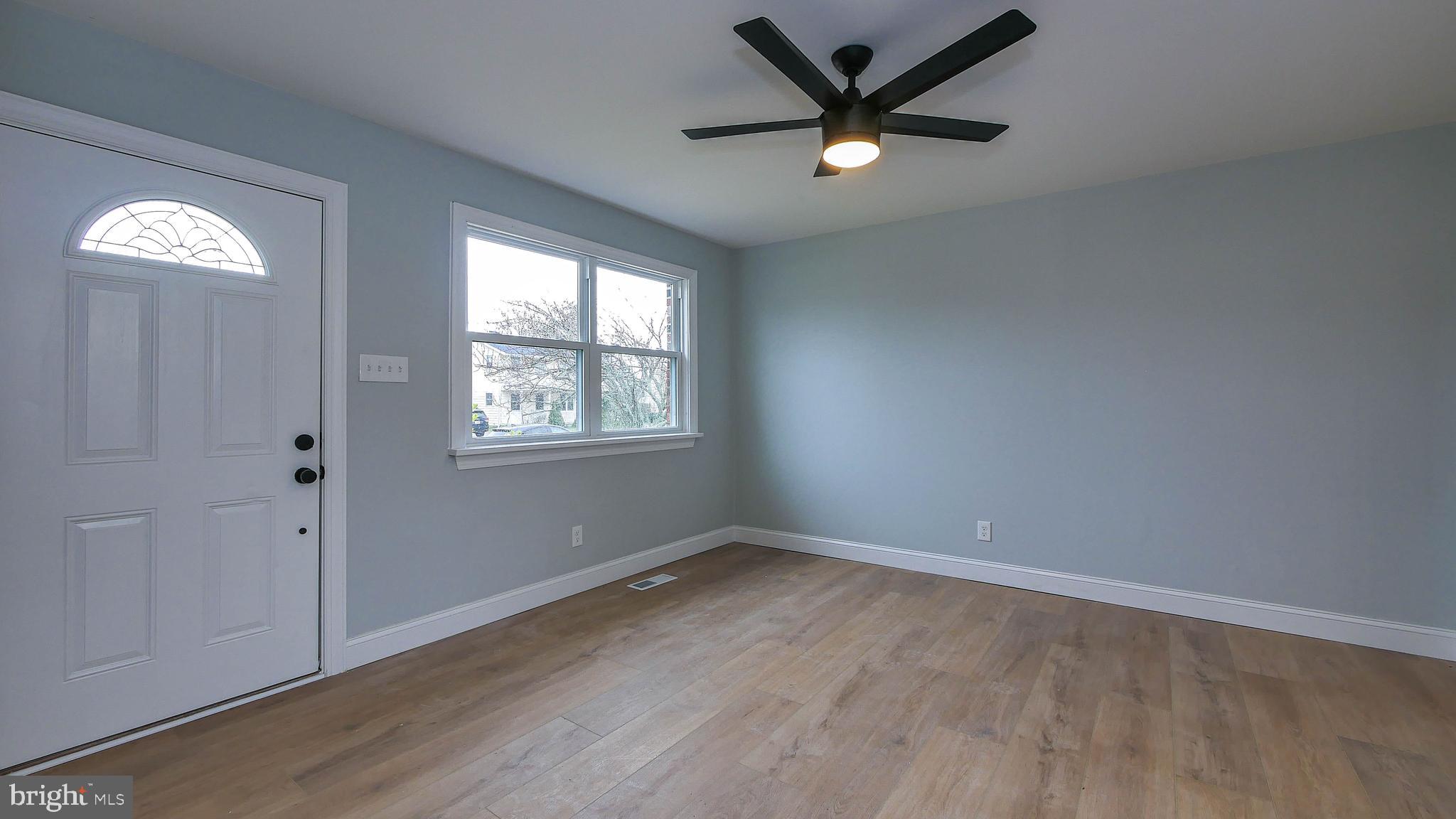4623 Schooner Road, Unit A Brigantine, NJ 08203 - Photo 26 of 30 an empty room with wooden floor a ceiling fan and windows