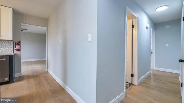 a view of a hallway with wooden floor