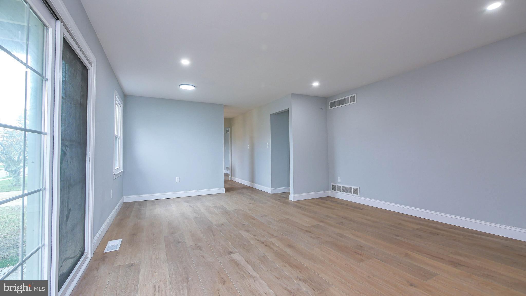 4623 Schooner Road, Unit A Brigantine, NJ 08203 - Photo 6 of 30 a view of an empty room with wooden floor and a window