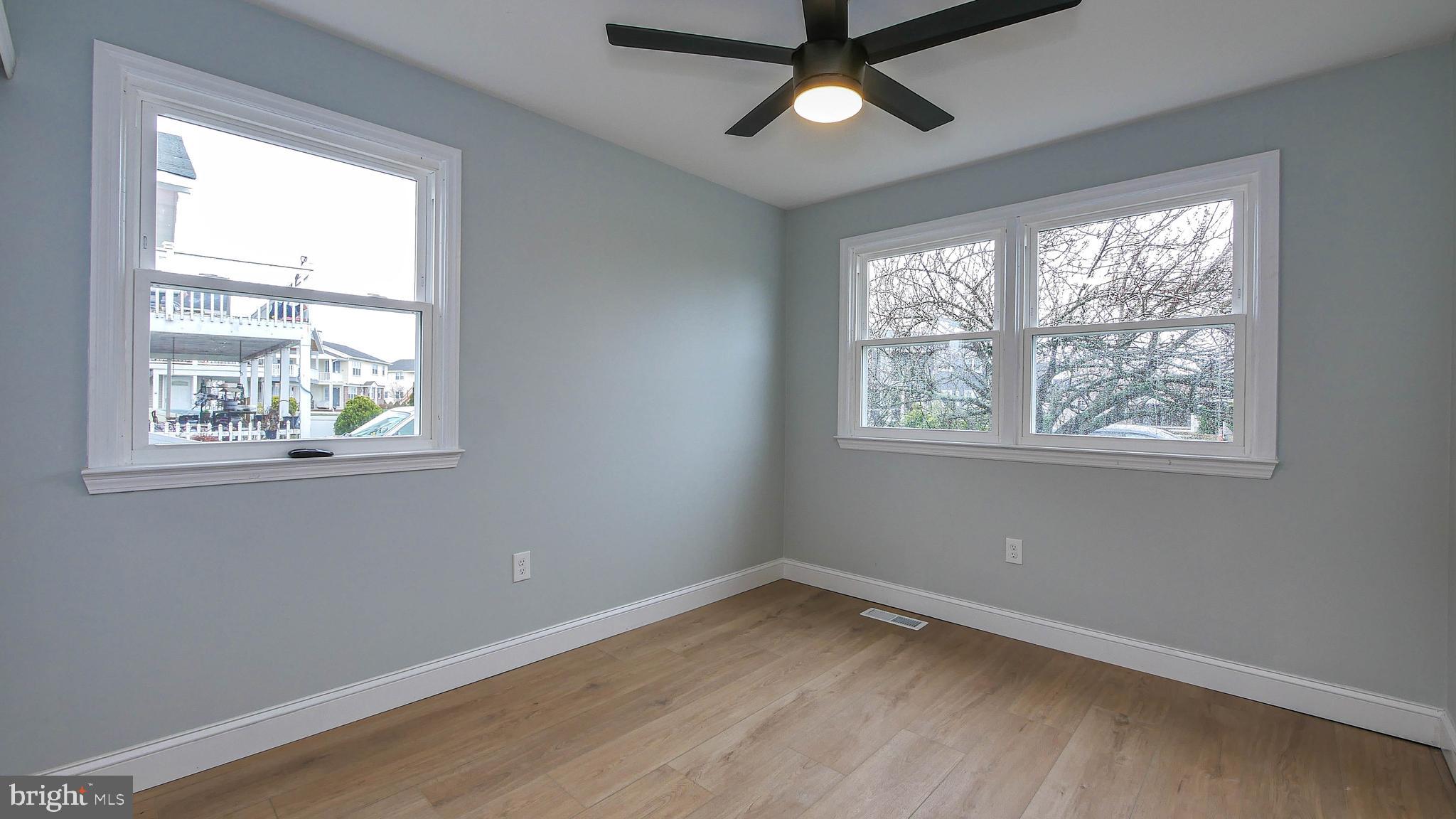 4623 Schooner Road, Unit A Brigantine, NJ 08203 - Photo 10 of 30 a view of an empty room with wooden floor and a window