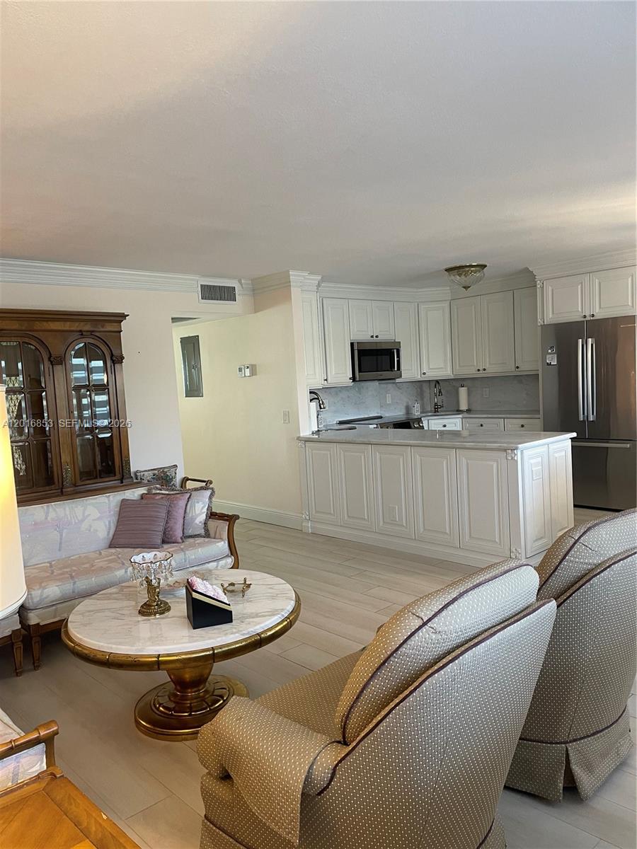 2091 Yarmouth East, Unit 2091 Boca Raton, FL 33434 - Photo 11 of 15 a kitchen with a dining table and chairs