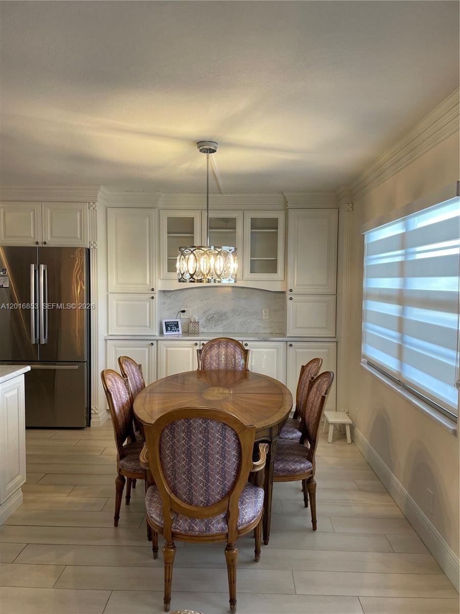 2091 Yarmouth East, Unit 2091 Boca Raton, FL 33434 - Photo 12 of 15 a view of a dining room with furniture and window