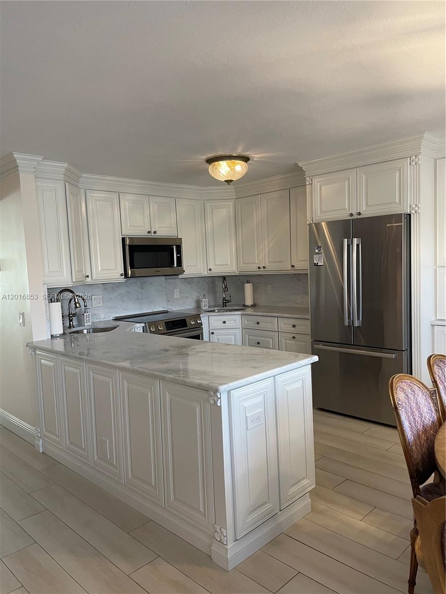 2091 Yarmouth East, Unit 2091 Boca Raton, FL 33434 - Photo 13 of 15 a kitchen with stainless steel appliances granite countertop a refrigerator sink and stove