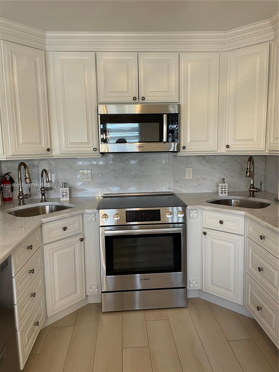 2091 Yarmouth East, Unit 2091 Boca Raton, FL 33434 - Photo 14 of 15 a kitchen with stainless steel appliances granite countertop a stove a sink and dishwasher