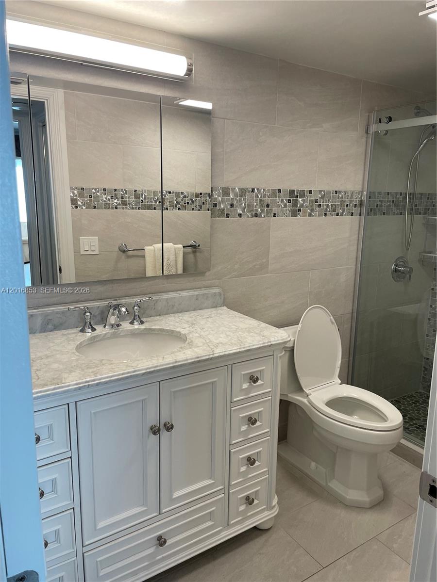 2091 Yarmouth East, Unit 2091 Boca Raton, FL 33434 - Photo 4 of 15 a bathroom with a granite countertop toilet sink and mirror