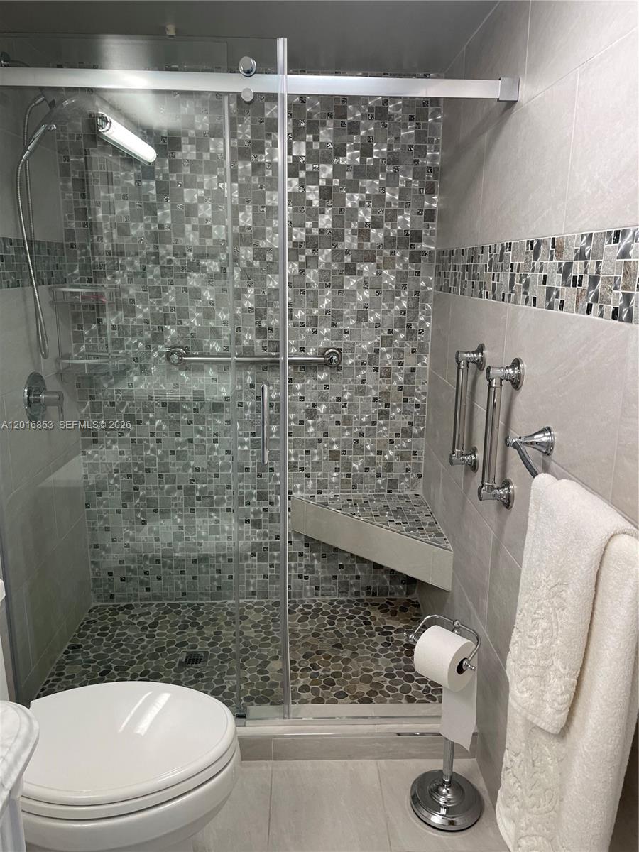 2091 Yarmouth East, Unit 2091 Boca Raton, FL 33434 - Photo 5 of 15 a bathroom with a toilet and a shower
