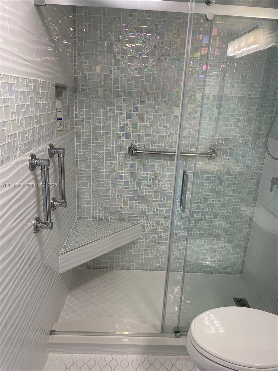 2091 Yarmouth East, Unit 2091 Boca Raton, FL 33434 - Photo 7 of 15 a bathroom with a white toilet and a shower
