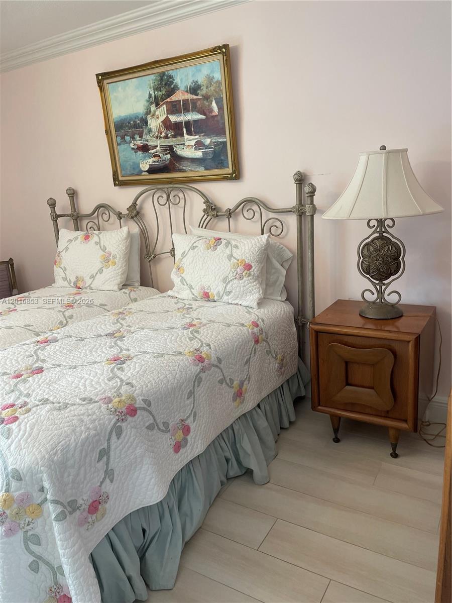 2091 Yarmouth East, Unit 2091 Boca Raton, FL 33434 - Photo 9 of 15 a bedroom with a bed and painting on the wall