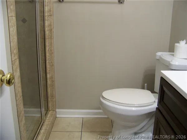 a white toilet sitting next to a bathroom sink