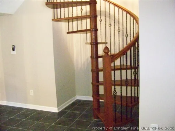 a view of staircase with rug