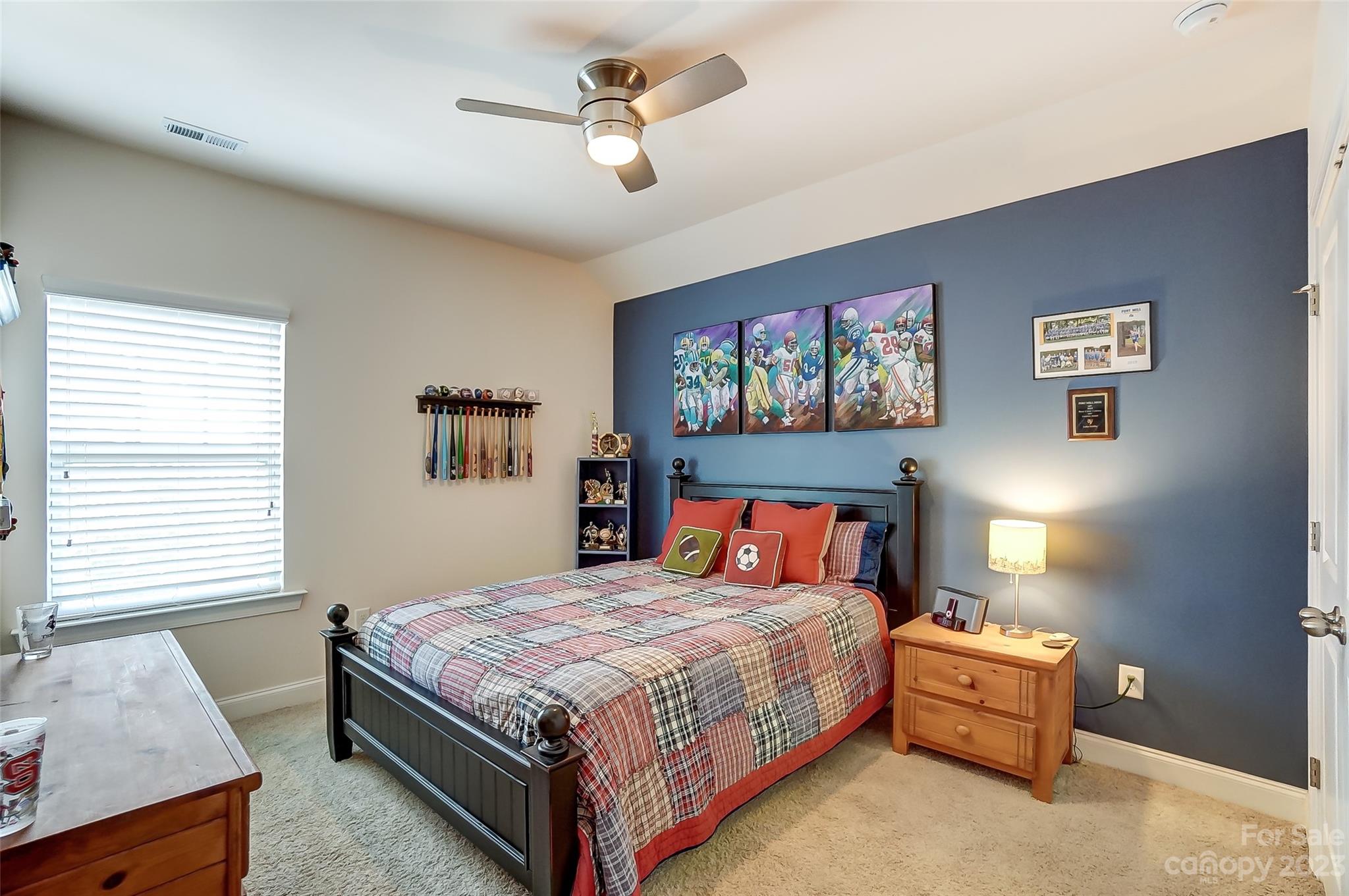 116 Helton Lane Fort Mill, SC 29708 - Photo 25 of 41 a bedroom with a bed and a chandelier