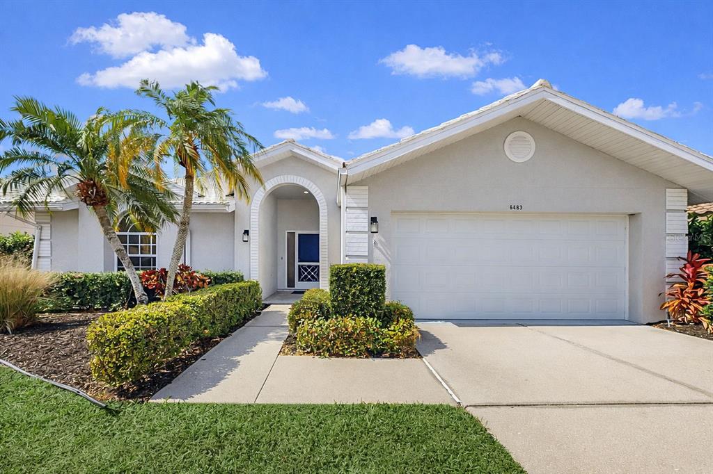 6409 Stone River Road Bradenton, FL 34203 - Photo 1 of 72 a front view of a house with a garden