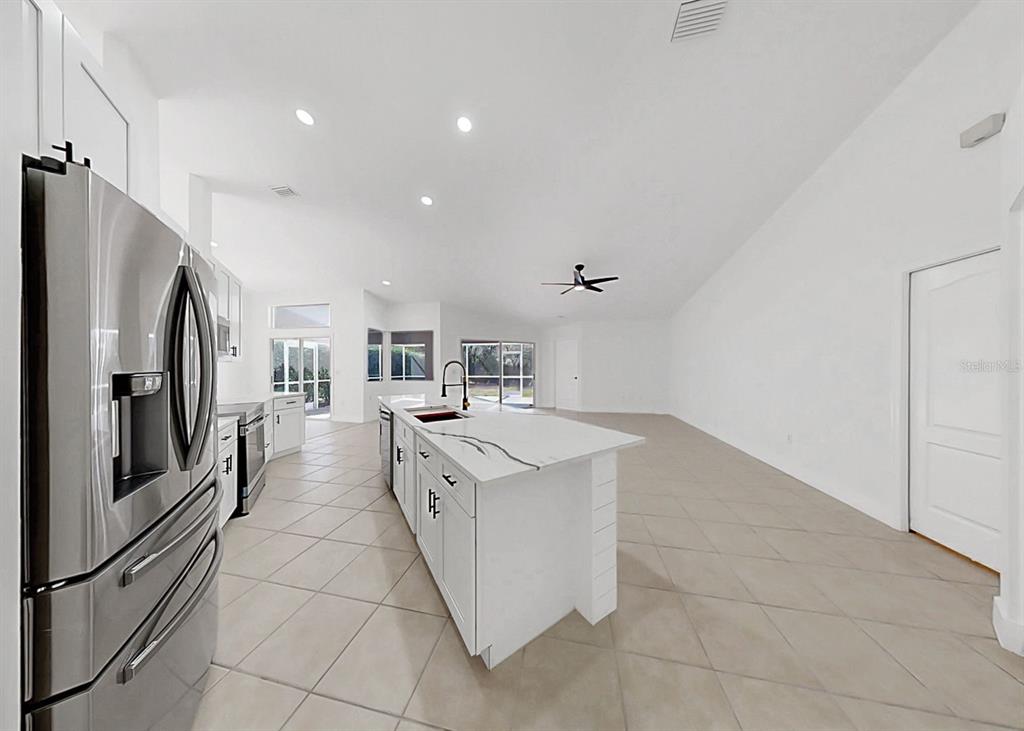 6409 Stone River Road Bradenton, FL 34203 - Photo 27 of 72 a kitchen with stainless steel appliances granite countertop a refrigerator and a stove