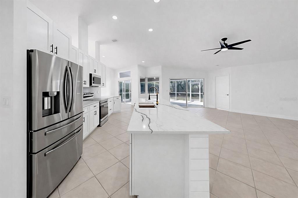 6409 Stone River Road Bradenton, FL 34203 - Photo 30 of 72 a kitchen with stainless steel appliances a refrigerator sink and cabinets