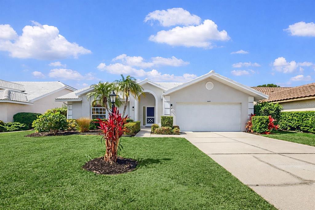 6409 Stone River Road Bradenton, FL 34203 - Photo 3 of 72 a front view of a house with garden