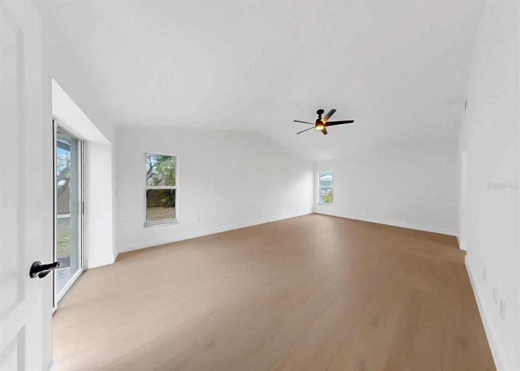 6409 Stone River Road Bradenton, FL 34203 - Photo 35 of 72 a view of a livingroom with a ceiling fan and window