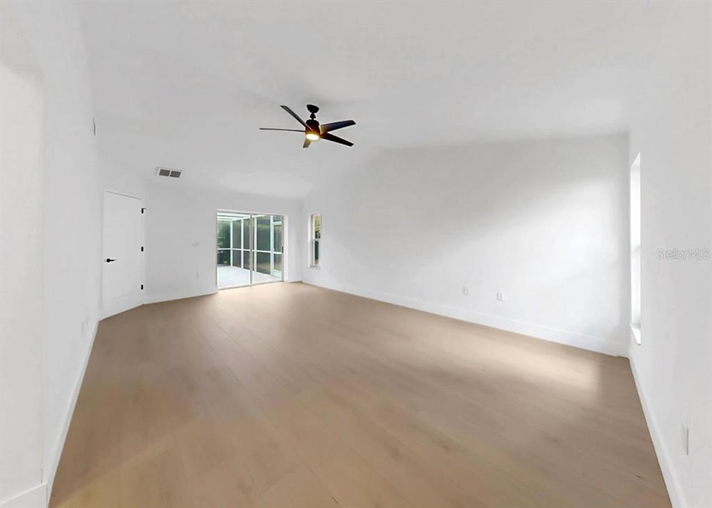 6409 Stone River Road Bradenton, FL 34203 - Photo 37 of 72 an empty room with a empty space and a ceiling fan