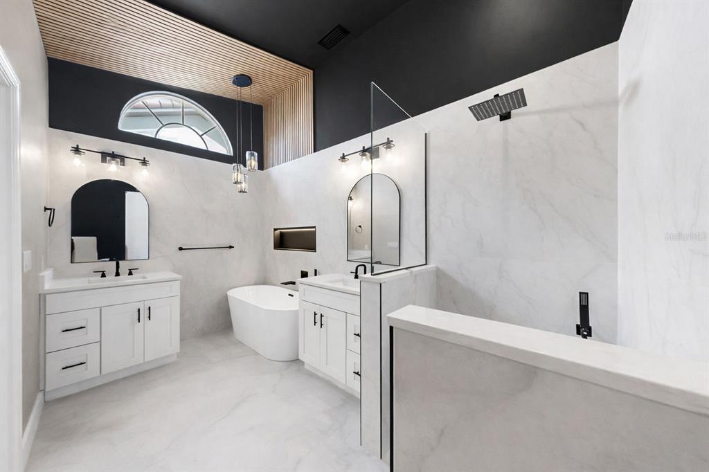 6409 Stone River Road Bradenton, FL 34203 - Photo 40 of 72 a bathroom with a double vanity sink mirror and bathtub