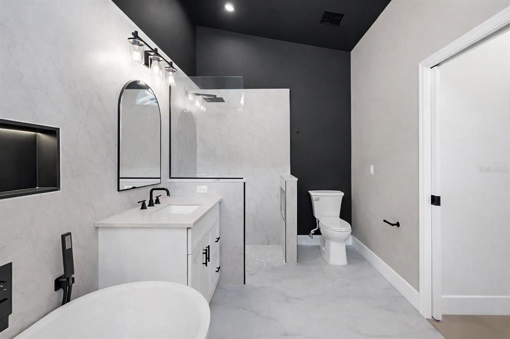 6409 Stone River Road Bradenton, FL 34203 - Photo 46 of 72 a bathroom with a toilet sink and mirror