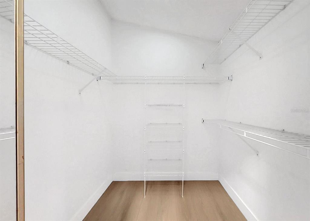 6409 Stone River Road Bradenton, FL 34203 - Photo 47 of 72 a view of walk in closet with empty racks