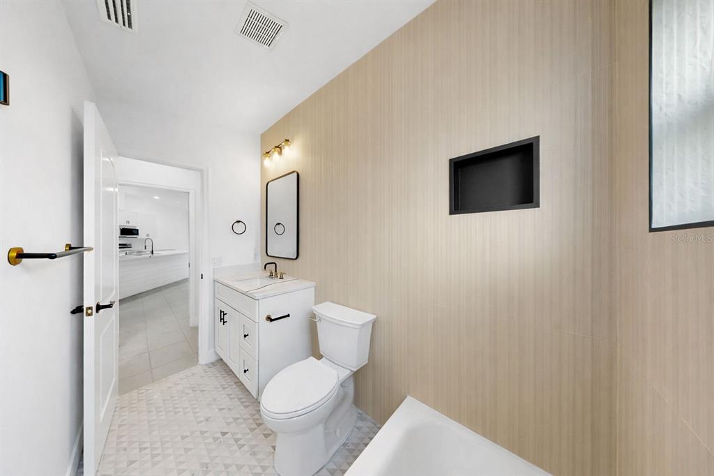 6409 Stone River Road Bradenton, FL 34203 - Photo 51 of 72 a bathroom with a toilet sink a mirror and shower